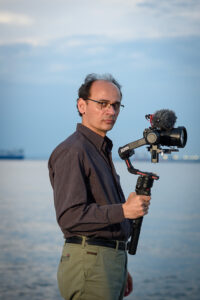 About - Cameraman looking at camera About - Cameraman looking at camera